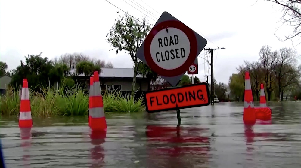A sign reading u00e2u20acu02dcRoad Closed. Floodingu00e2u20acu2122 is seen in floodwaters in Canterbury region, New Zealand, May 30, 2021, in this still image obtained from a video. u00e2u20acu201d TVNZ via Reuters TV