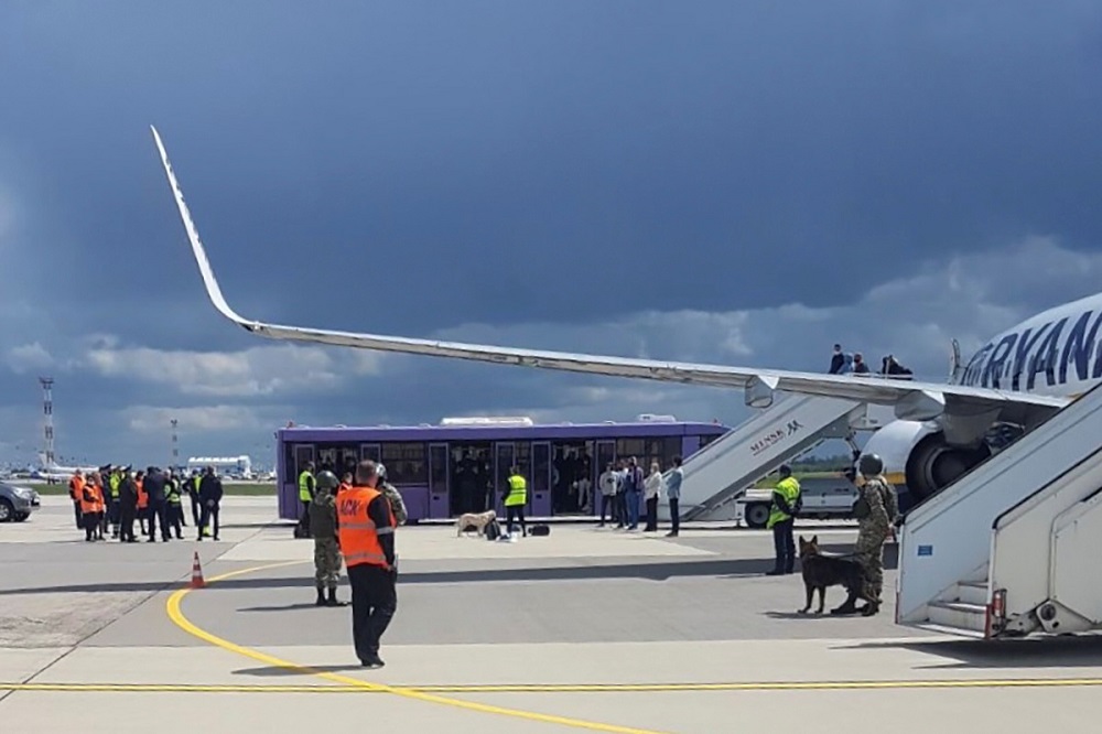 Airport personnel and security forces are seen on the tarmac in front of a Ryanair flight which was forced to land in Minsk, Belarus, May 23, 2021. u00e2u20acu2022 Handout via Reuters