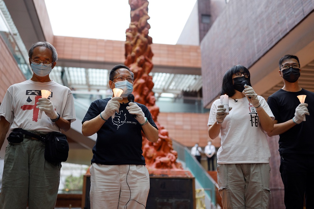 Vice-chairman of Hong Kong Alliance in Support of Patriotic Democratic Movements of China, Albert Ho Chun-Yan and Chow Hang-tung hold candles beside the u00e2u20acu02dcPillar of Shameu00e2u20acu2122 inside the campus of the University of Hong Kong, Hong Kong May 2, 2021. u00e2u20acu2022 Reu