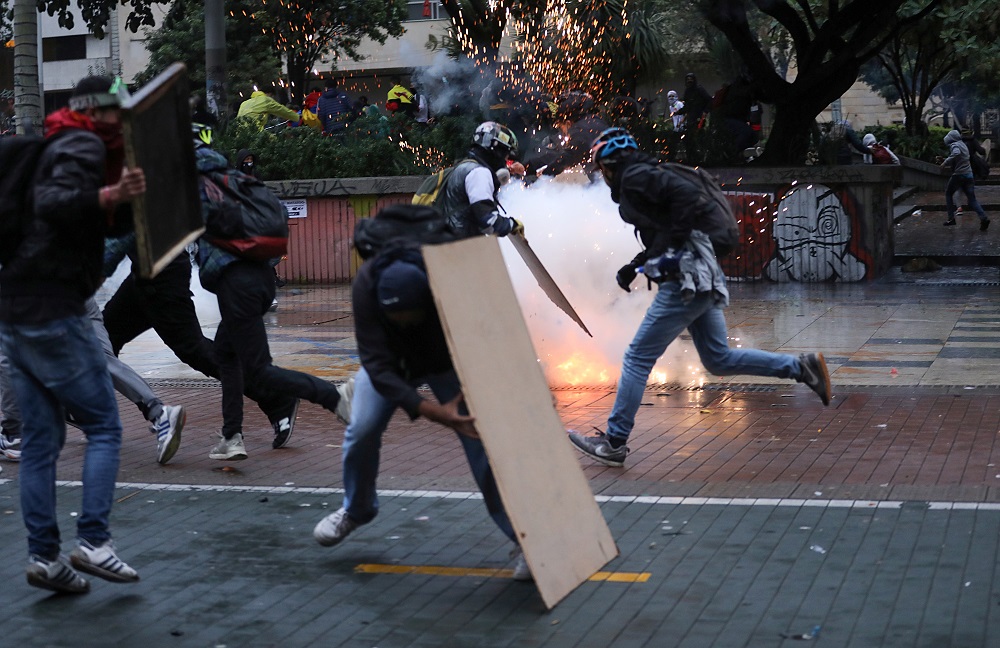 Demonstrators run and take cover during a protest against poverty and police violence in Bogota, Colombia, May 5, 2021. u00e2u20acu2022 Reuters pic