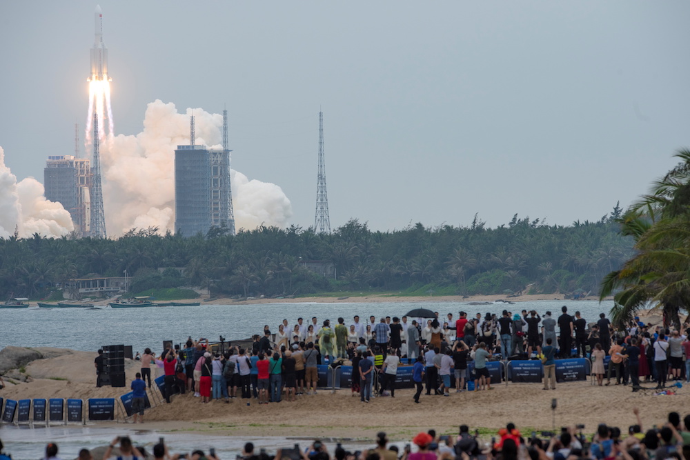 People watch from a beach as the Long March-5B Y2 rocket, carrying the core module of China’s space station Tianhe, takes off from Wenchang Space Launch Center in Hainan province, China April 29, 2021. ― Reuters pic 