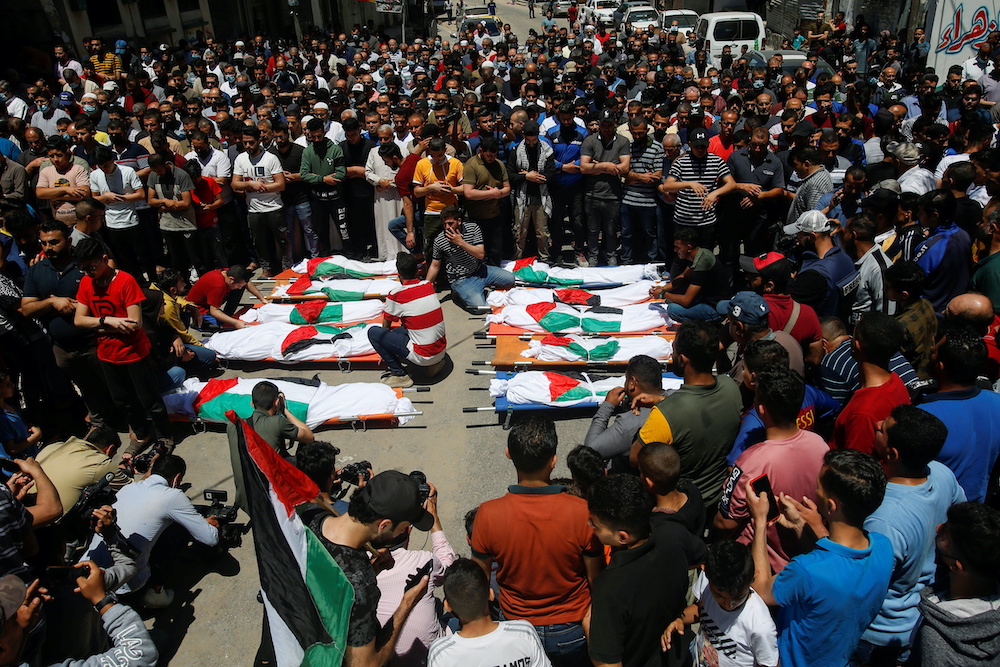Mourners offer funeral prayers next to the bodies of Palestinians, including members of Abu Hatab family, who were killed amid a flare-up of Israeli-Palestinian violence, at the Beach refugee camp, in Gaza City May 15, 2021. u00e2u20acu2022 Reuters picnnn