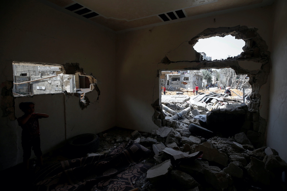 A girl standing in a damaged house looks on as Palestinians return to their homes following Israel- Hamas truce, in Beit Hanoun in the northern Gaza Strip, May 21, 2021. — Reuters pic