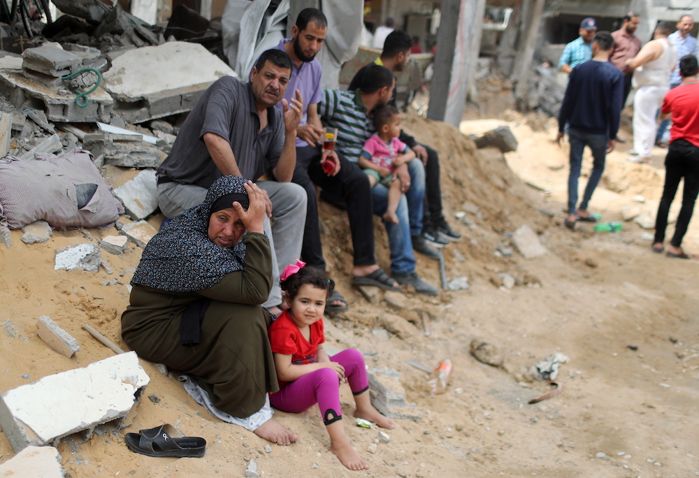 A Palestinian woman reacts after returning to her destroyed house following Israel- Hamas truce, in Beit Hanoun in the northern Gaza Strip, May 21, 2021. — Reuters pic