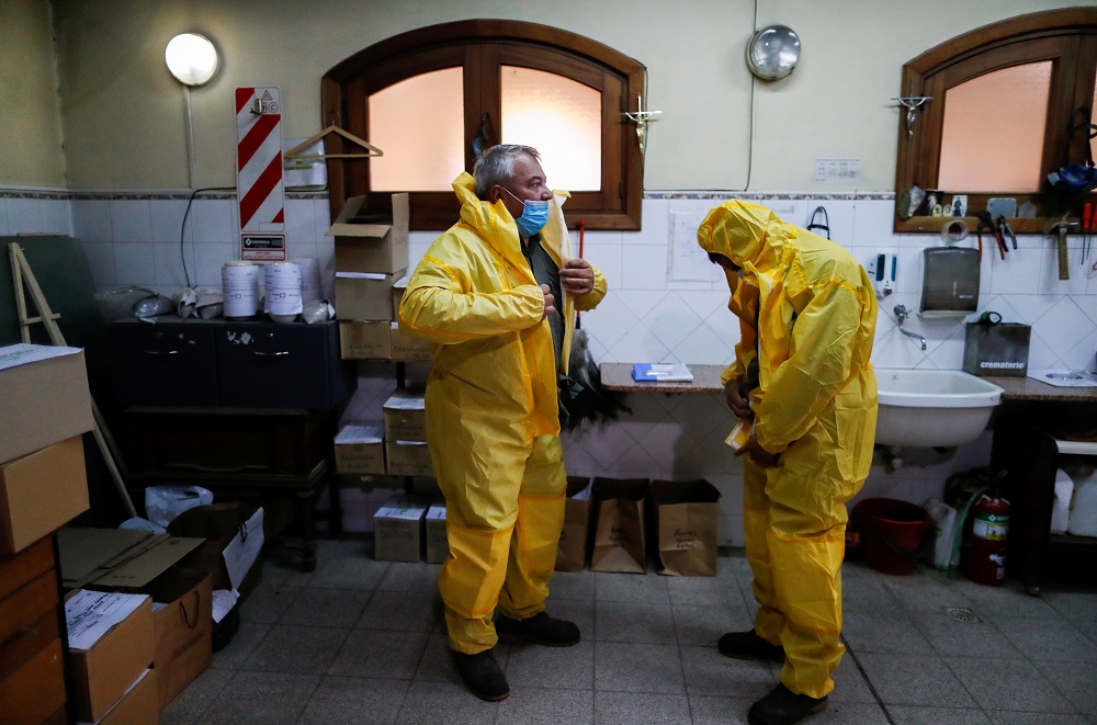 Ernesto Fabian Aguirre, a gravedigger in the Memorial cemetery, stands next to a coworker as they put on protective equipment before an exercise for Covid-19 burials in Buenos Aires, Argentina May 17, 2021. u00e2u20acu2022 Reuters pic