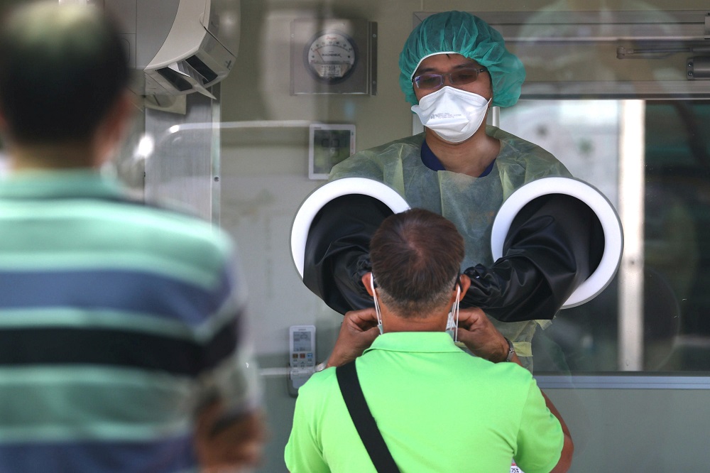 A medical worker uses a rapid test for Covid-19 on a Taiwanese resident following an increasing number of locally transmitted cases in Taipei May 25, 2021. u00e2u20acu2022 Reuters pic
