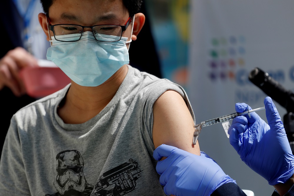 Brendan Lo (13) receives a dose of the Pfizer-BioNTech vaccine at Northwell Health's Cohen Children's Medical Center in New Hyde Park, New York May 13, 2021. u00e2u20acu2022 Reuters pic