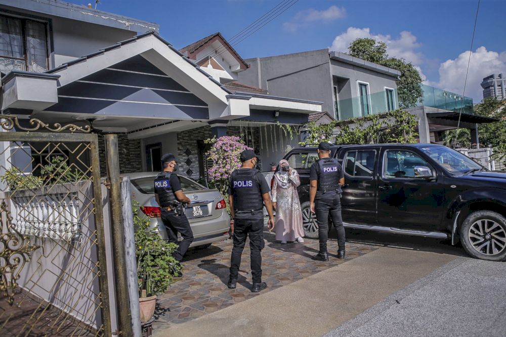 Members of the All-Black team from the Shah Alam Section 6 Police Station patrolling the housing area to prevent visiting activities on the second day of the Aidilfitri celebration during a survey, May 14, 2021. u00e2u20acu2022 Picture by Hari Anggara