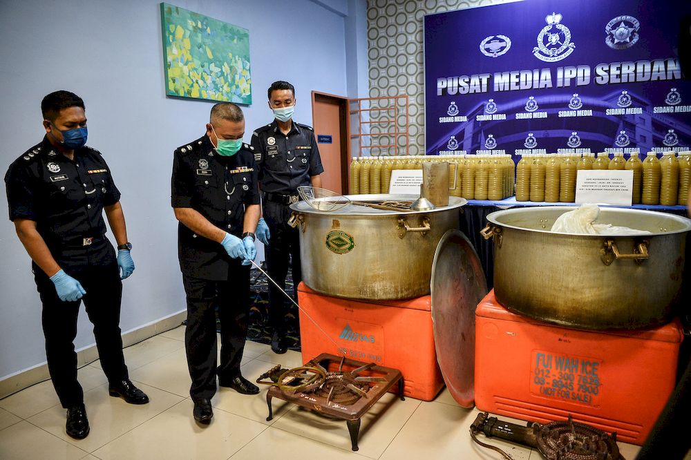 Acting Serdang District Police Chief Supt Mohd Rosdi Daud (center) shows various equipment seized including two large iron pots, two gas barrels and two iron furnaces believed to be used to process ketum water, May 5, 2021. u00e2u20acu201d Bernama pic