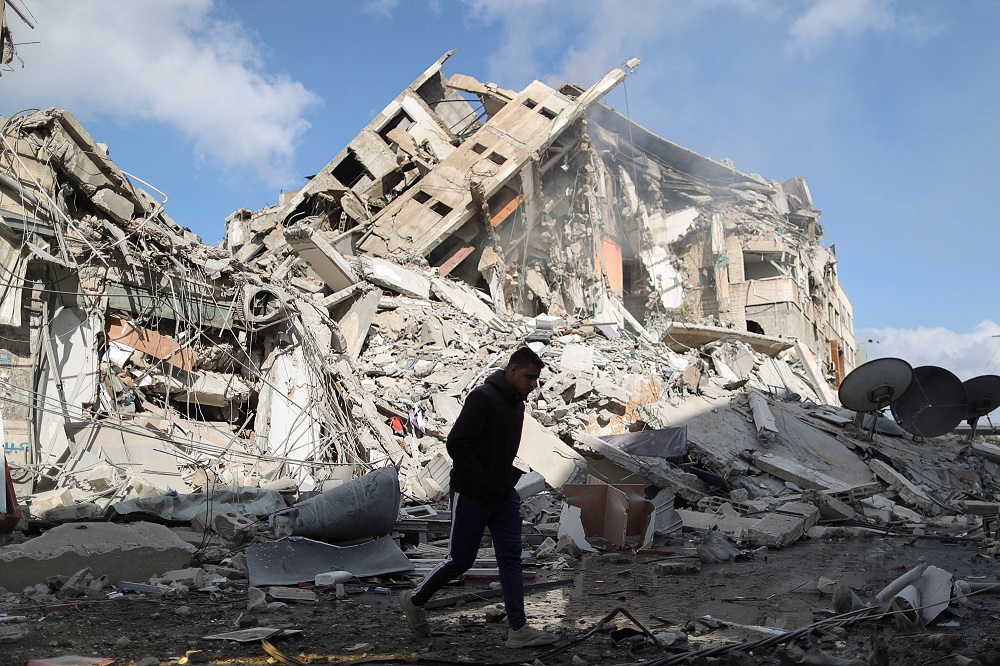 A Palestinian man walks past the remains of a tower building which was destroyed by Israeli air strikes, amid a flare-up of Israeli-Palestinian violence, in Gaza City May 13, 2021. u00e2u20acu2022 Reuters pic
