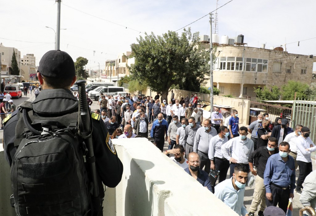 Palestinians wait at an Israeli checkpoint near the occupied-West Bank town of Bethlehem, to enter Jerusalem to attend the last Friday prayers of the Muslim holy month of Ramadan, on May 7, 2021. u00e2u20acu201d AFP pic