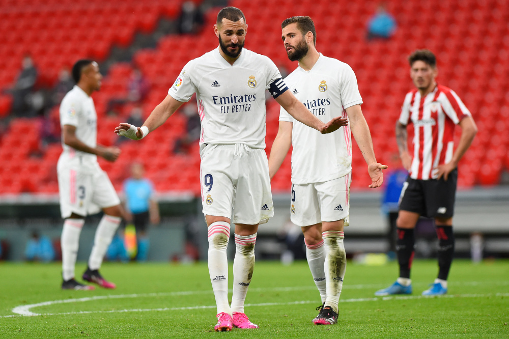 Real Madridu00e2u20acu2122s French forward Karim Benzema and Real Madridu00e2u20acu2122s Spanish defender Nacho Fernandez gesture during the Spanish League football match against Athletic Club Bilbao at the San Mames stadium in Bilbao, May 16, 2021. u00e2u20acu201d AFP pic 