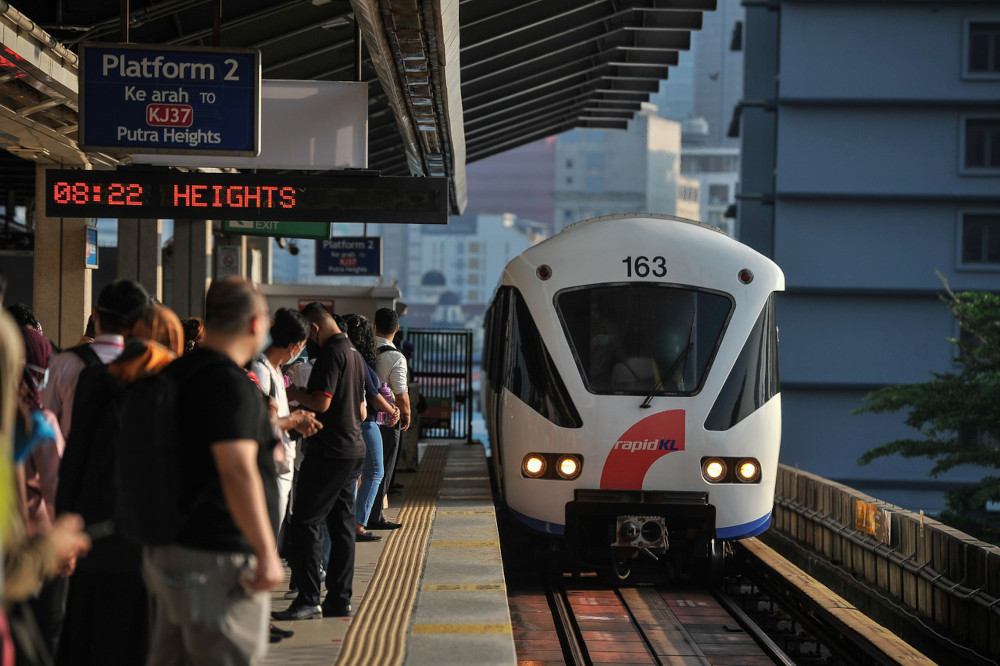 Light Rail Transit System (LRT) train passengers wait their turn to board the train to their respective destinations at Pasar Seni LRT Station, May 25, 2021. u00e2u20acu201d Bernama pic 