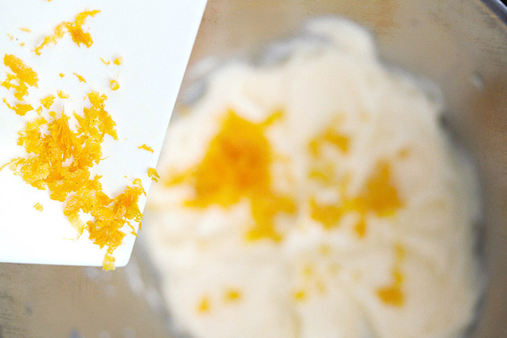 Add freshly grated zest to the beaten eggs and sugar.