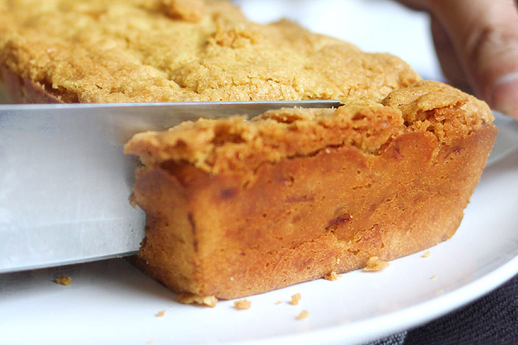 Cut the orange crumble cake into rectangular slices.