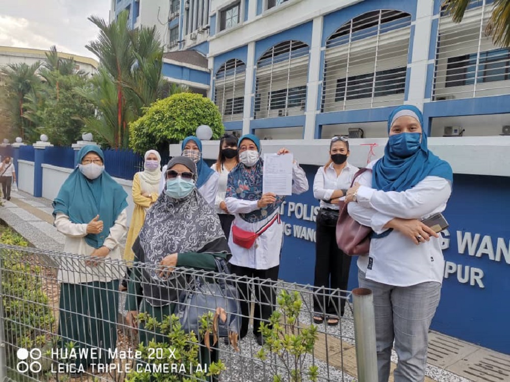 Pejuanita chief Datin Paduka Che Asmah Ibrahim shows a police report outside the Dang Wangi police station in Kuala Lumpur May 4, 2021. u00e2u20acu2022 Picture courtesy of Datin Paduka Che Asmah Ibrahim