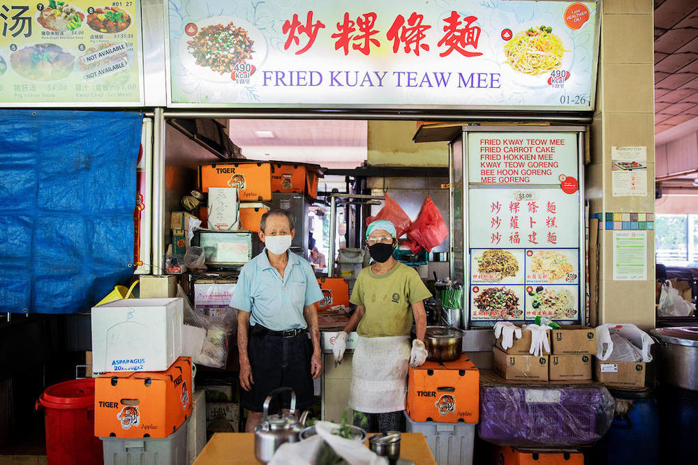 Mr Yeo Cheng Poh, 74, and Madam Toh Bong Chee, 73, who sell S$3 char kway teow and carrot cake at their stall, Fried Kuay Teaw Mee, at Seah Im Food Centre in the Harbourfront area, had resorted to working longer hours to make up for the shortfall in incom