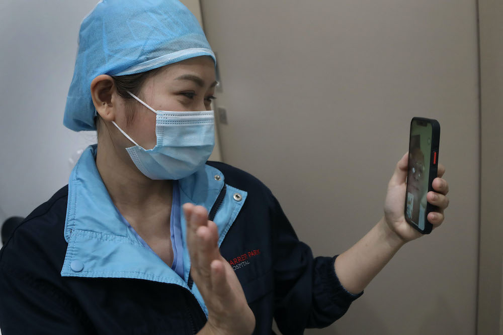 Filipino staff nurse Princess Joyce Aguas speaking to her father via a video call. When her family members in the Philippines contracted Covid-19 last month, all she could do was to assist virtually with advice. ― Photo by Raj Nadarajan for TODAY