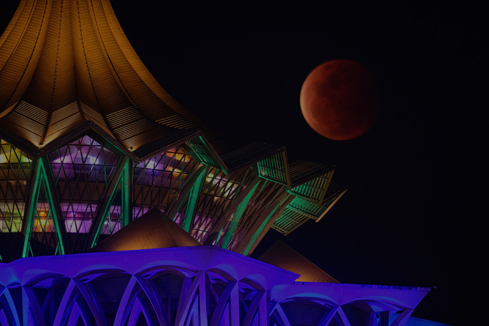 The Super Flower Blood Moon lunar eclipse seen from the Sarawak State Legislative Assembly building in Kuching, May 26, 2021. u00e2u20acu201d Bernama pic