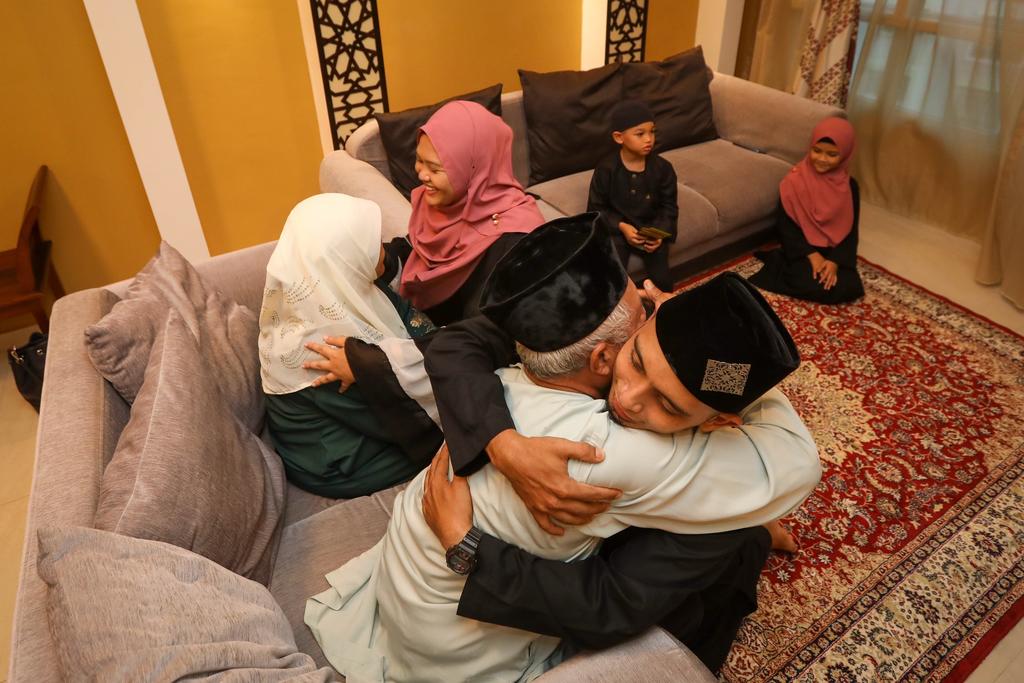Umar Abdul Latif (right in foreground) and his family hosted his in-laws at his home on the first day of Hari Raya Puasa, May 13, 2021. u00e2u20acu2022 TODAY pic