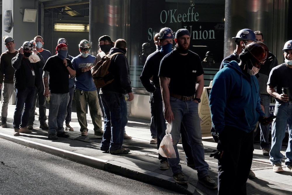 Construction workers wait in line to do a temperature test to return to the job site after lunch, amid the coronavirus disease outbreak, in the Manhattan borough of New York City, New York, US, November 10, 2020. ― Reuters pic 