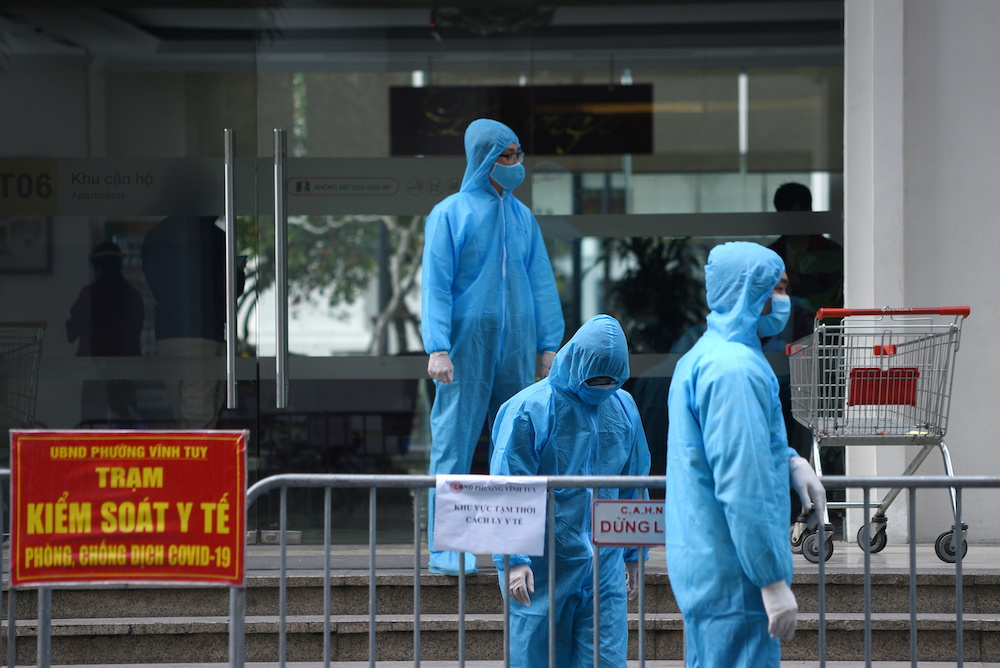 Medical workers in protective suits stand outside a quarantined building amid the coronavirus disease outbreak in Hanoi, Vietnam, January 29, 2021. u00e2u20acu201d Reuters picnn
