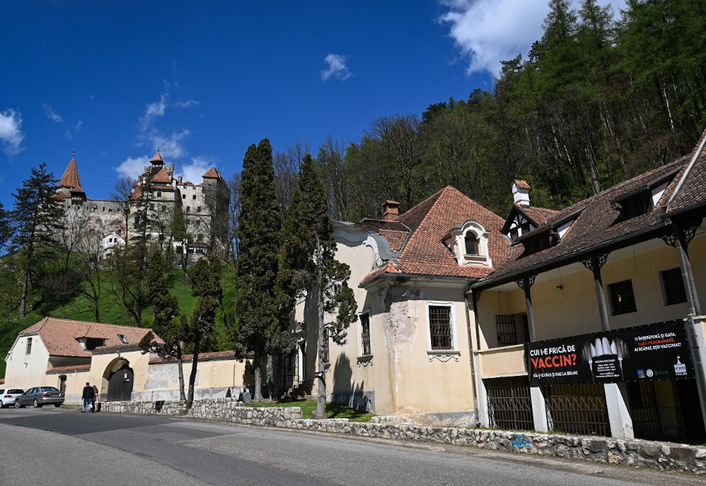 A banner reading in Romanian u00e2u20acu02dcWhou00e2u20acu2122s afraid of vaccineu00e2u20acu2122 and depicting syringes as vampire fangs advertises the vaccination marathon organised at the Bran Castle (in background) in Bran village on May 8, 2021. u00e2u20acu201d AFP pic