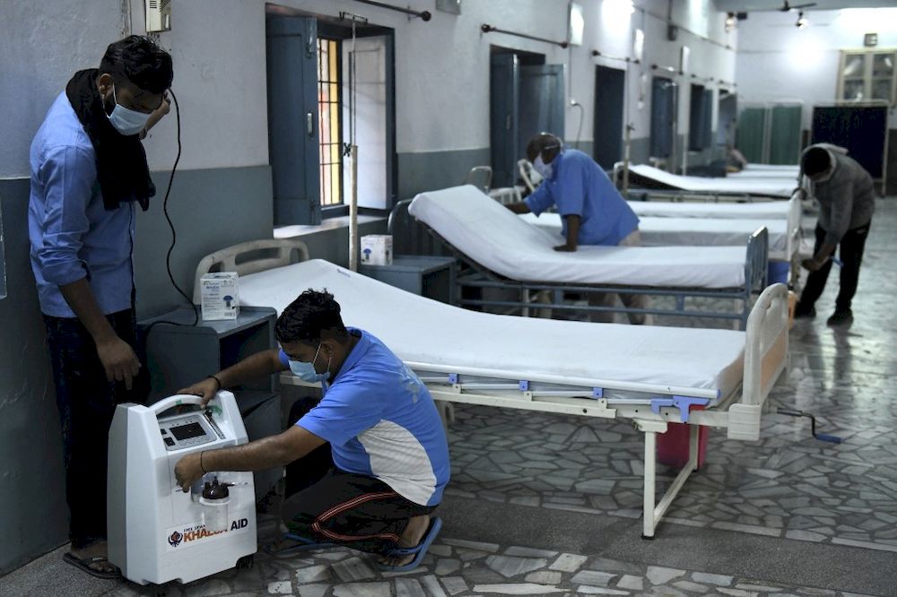 Employees of a charitable society check an oxygen concentrator machine placed near beds for the Covid-19 coronavirus patients at a care centre in Amritsar on May 7, 2021. u00e2u20acu201d AFP pic