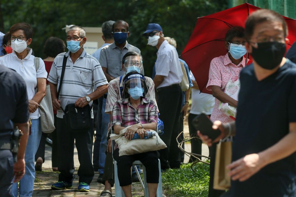 Senior citizens queue up to receive the Covid-19 vaccine outside the Bandar Sri Menjalara community hall in Kuala Lumpur May 25, 2021. u00e2u20acu2022 Picture by Ahmad Zamzahurinn