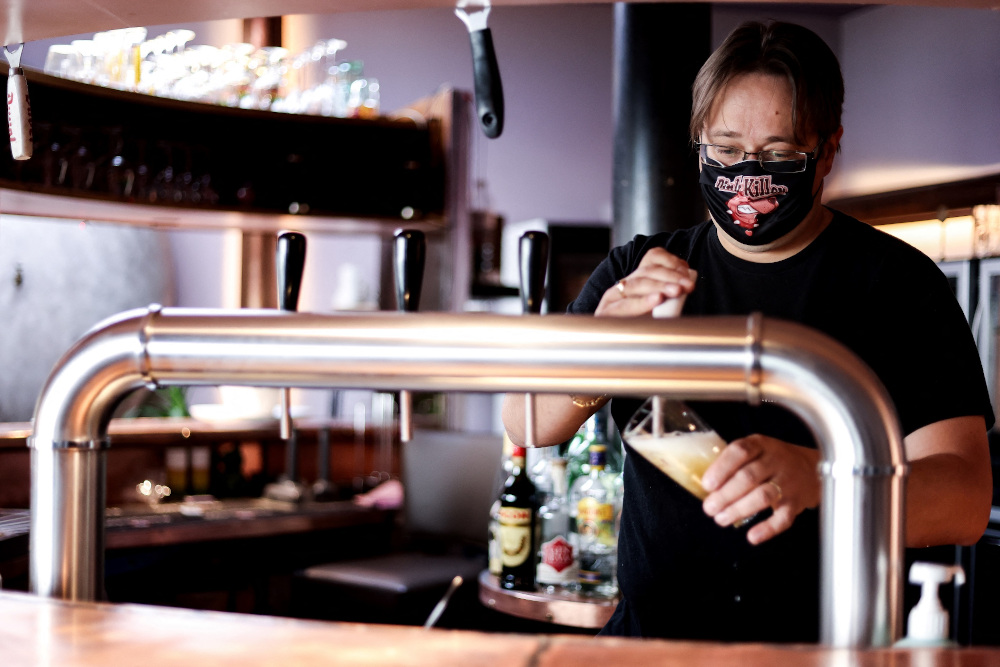 Sebastien Weverbergh, manager of the Cafu00c3u00a9 de la Brasserie prepares his bar for reopening and checks the equipment and beer faucet or tap handle. u00e2u20acu201d AFP pic