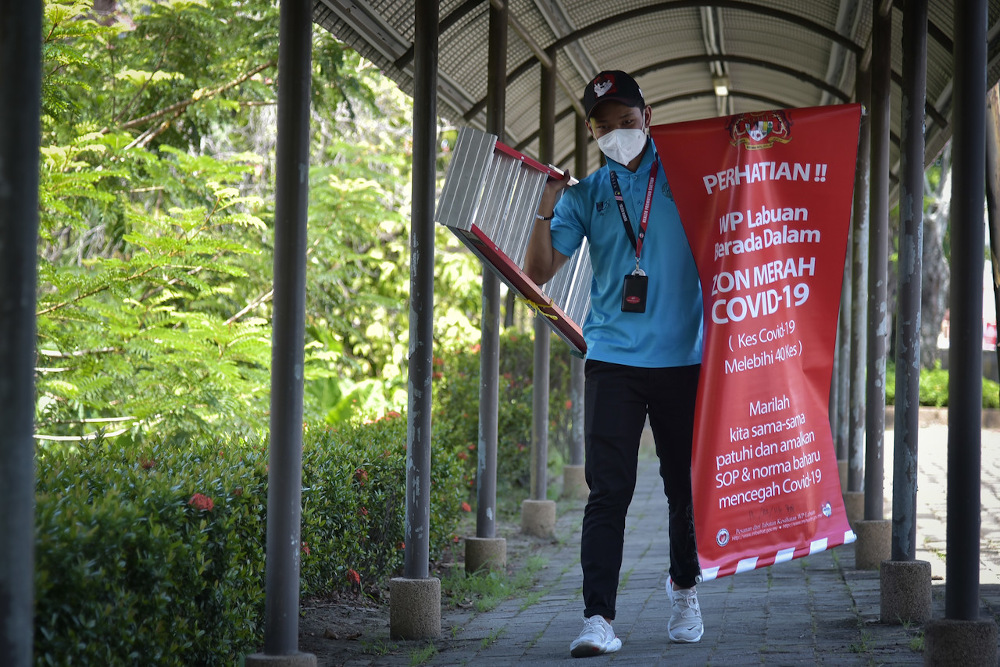 Nearly 200 Covid-19 red zone banners were ordered to be taken down with immediate effect, leaving local residents questioning the motive. u00e2u20acu201d Bernama pic