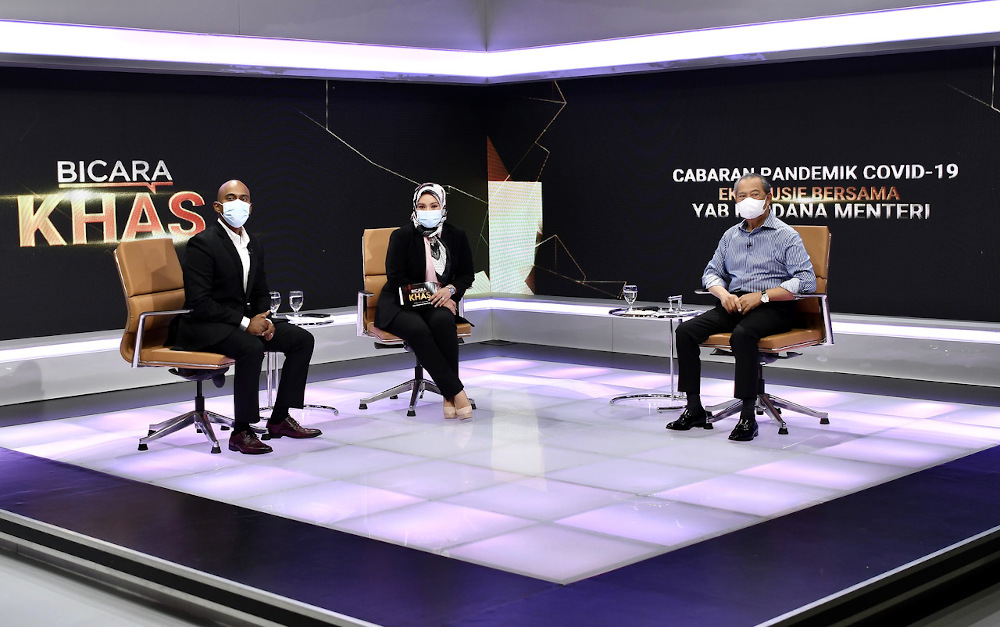 Prime Minister Tan Sri Muhyiddin Yassin (right) is seen during the u00e2u20acu02dcBicara Khasu00e2u20acu2122 programme broadcast at the Angkasapuri building in Kuala Lumpur May 23, 2021. u00e2u20acu201d Bernama pic