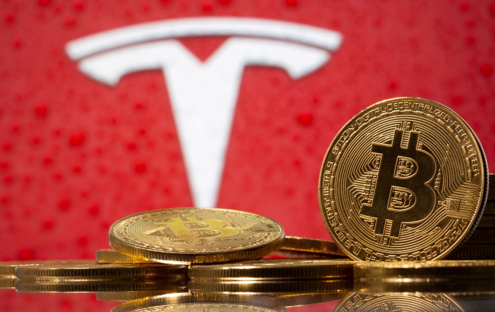 Representations of virtual currency Bitcoin are seen in front of Tesla logo in this illustration taken, February 9, 2021. u00e2u20acu201d Reuters pic