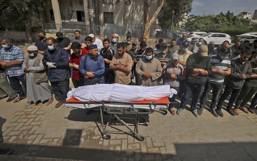 Palestinians pray over the body of a man killed during Israeli airstrikes in Gaza City on May 20, 2021. u00e2u20acu201d AFP pic