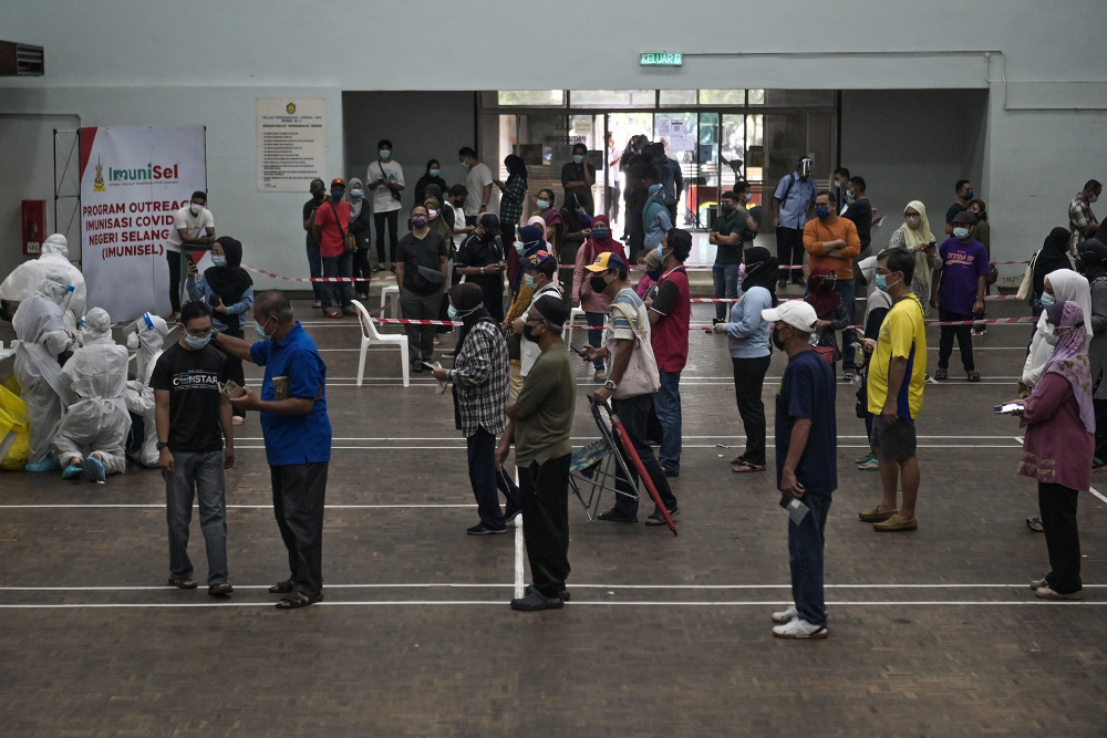 People wait in line for a Covid-19 public community screening by Selcare in Hulu Kelang, May 18, 2021. u00e2u20acu201d Picture by Miera Zulyana