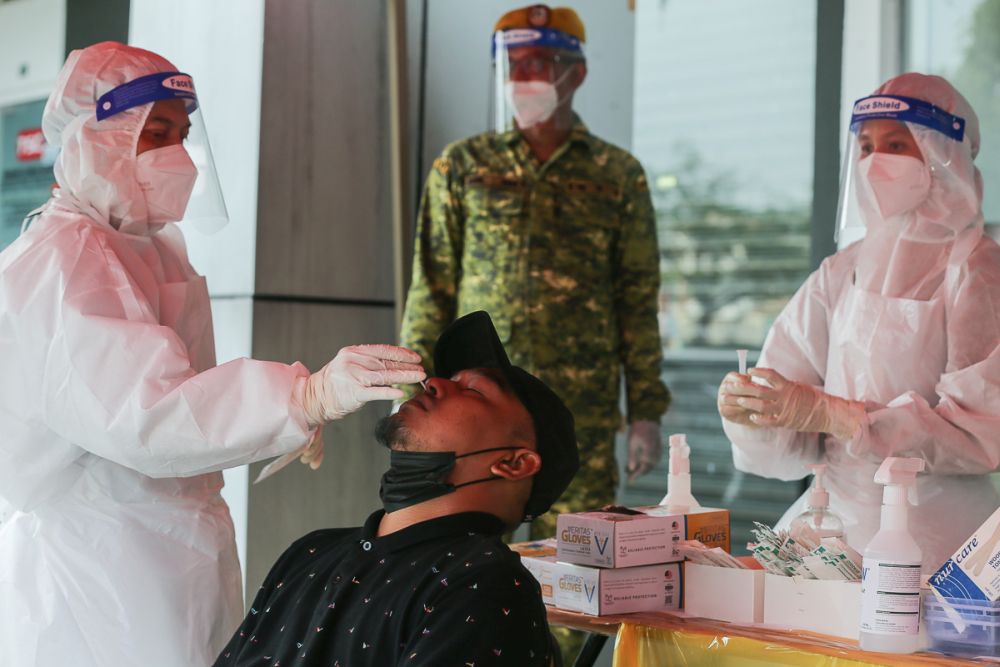 Health workers collect swab samples to test for Covid-19 at the Selcare Clinic in Shah Alam May 18, 2021. u00e2u20acu201d Picture by Yusof Mat Isa