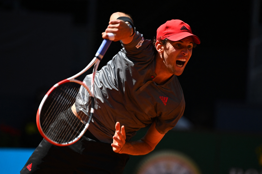 Austriau00e2u20acu2122s Dominic Thiem returns the ball to Australiau00e2u20acu2122s Alex De Minaur during their 2021 ATP Tour Madrid Open tennis tournament singles match at the Caja Magica in Madrid May 6, 2021. u00e2u20acu201d AFP picnn