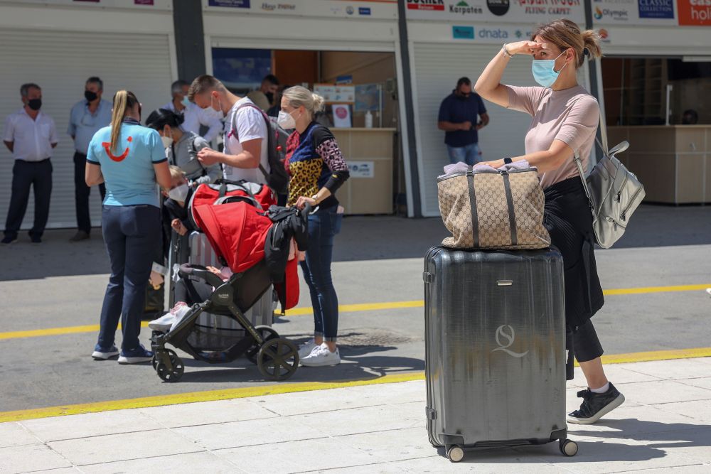 A woman wearing a protective face mask stands with to her luggage as passengers from Germany and Switzerland arrive at the Heraklion airport, during the country's official tourism season opening, on the island of Crete May 15, 2021. u00e2u20acu201d Reuters pic