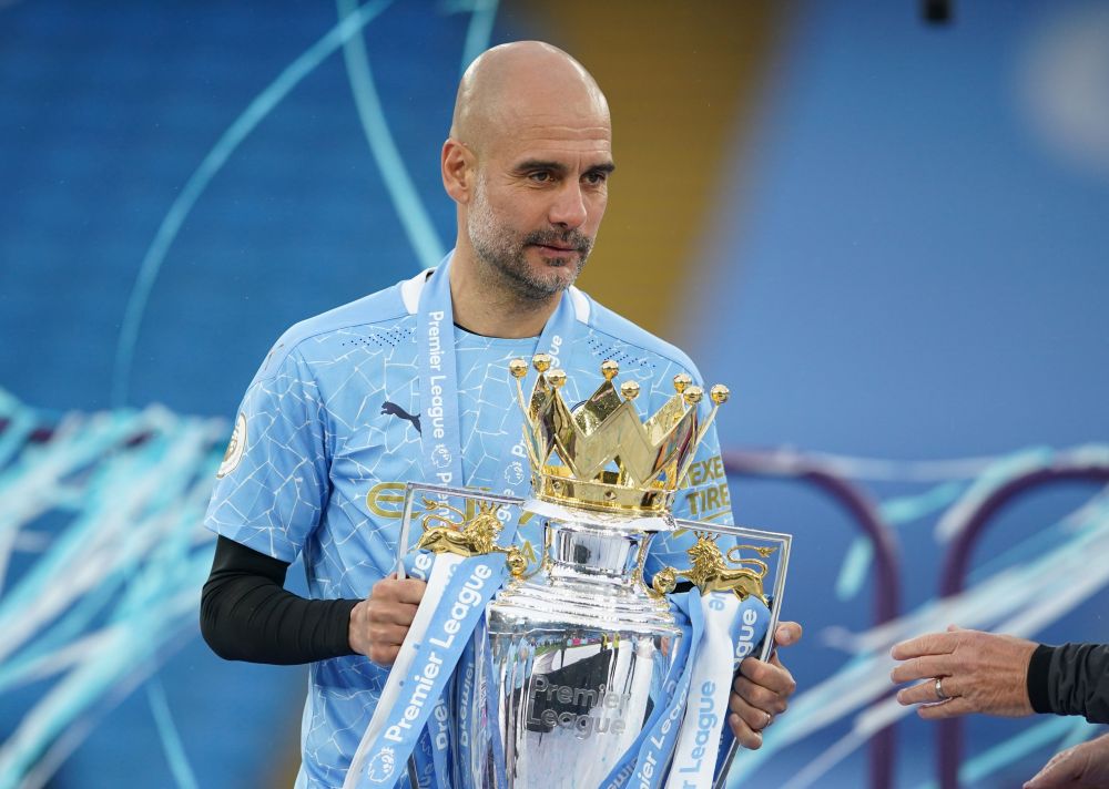 Manchester City manager Pep Guardiola celebrates with the trophy after winning the Premier League at the Etihad Stadium May 23, 2021. u00e2u20acu201d Reuters pic
