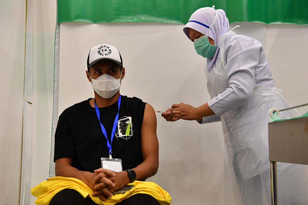 Harimau Malaya skipper Mohd Aidil Zafuan Abd Radzak gets his first Covid-19 vaccination in Putrajaya, April 19, 2021. u00e2u20acu201d Bernama pic    