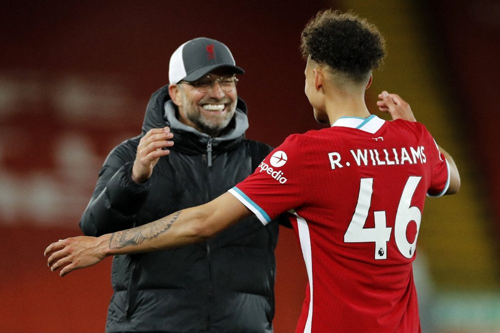 Liverpoolu00e2u20acu2122s manager Jurgen Klopp (left) celebrates with Liverpoolu00e2u20acu2122s defender Rhys Williams on the pitch after the Premier League match between Liverpool and Southampton at Anfield in Liverpool, May 8, 2021. Liverpool won the game 2-0. u00e2u20acu201d AFP pic