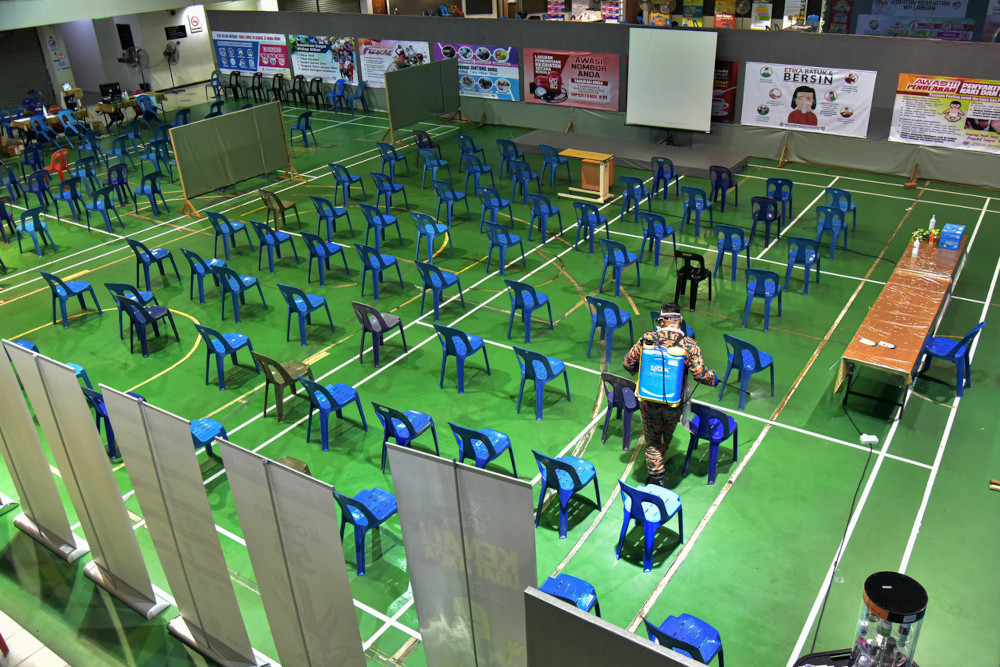 Hazmat personnel carry out sanitisation works at the Labuan Vaccination Centre, May 18, 2021. u00e2u20acu201d Bernama pic 