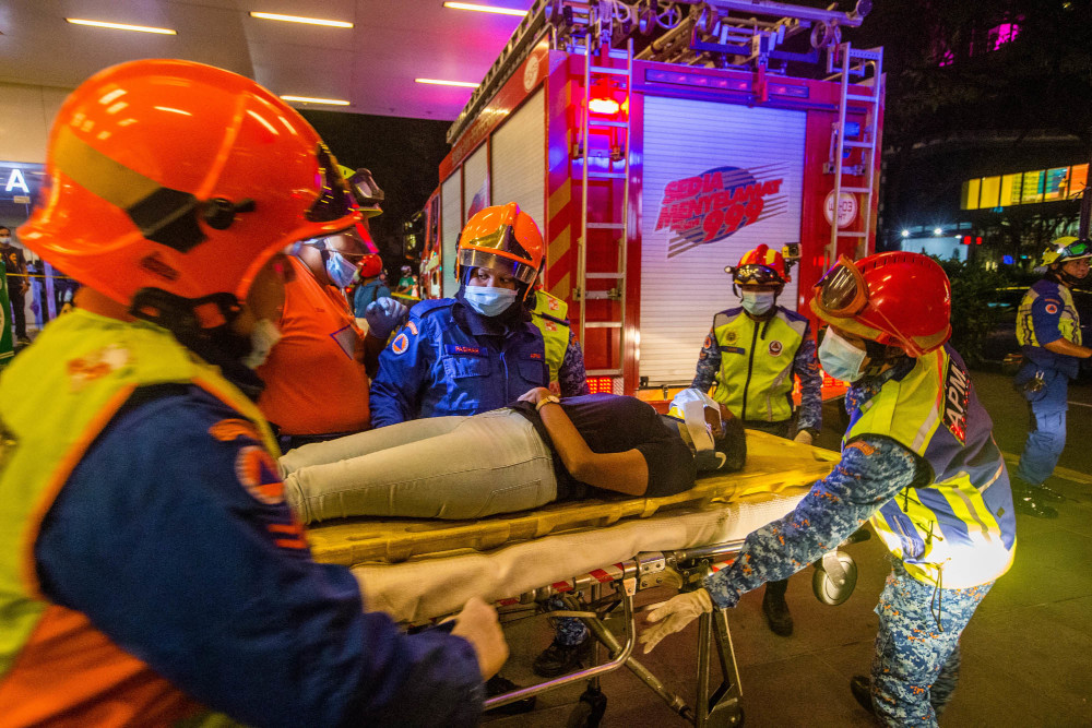 Rescue personnel tending to injured passengers at KLCC station during an incident involving trains numbered 40 and 81 at the LRT Kelana Jaya line, May 24, 2021. u00e2u20acu201d Picture by Firdaus Latifn