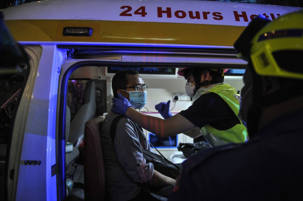 A commuter receives treatment folllowing an LRT train crash near Kampung Baru station May 24, 2021. u00e2u20acu201d Bernama pic