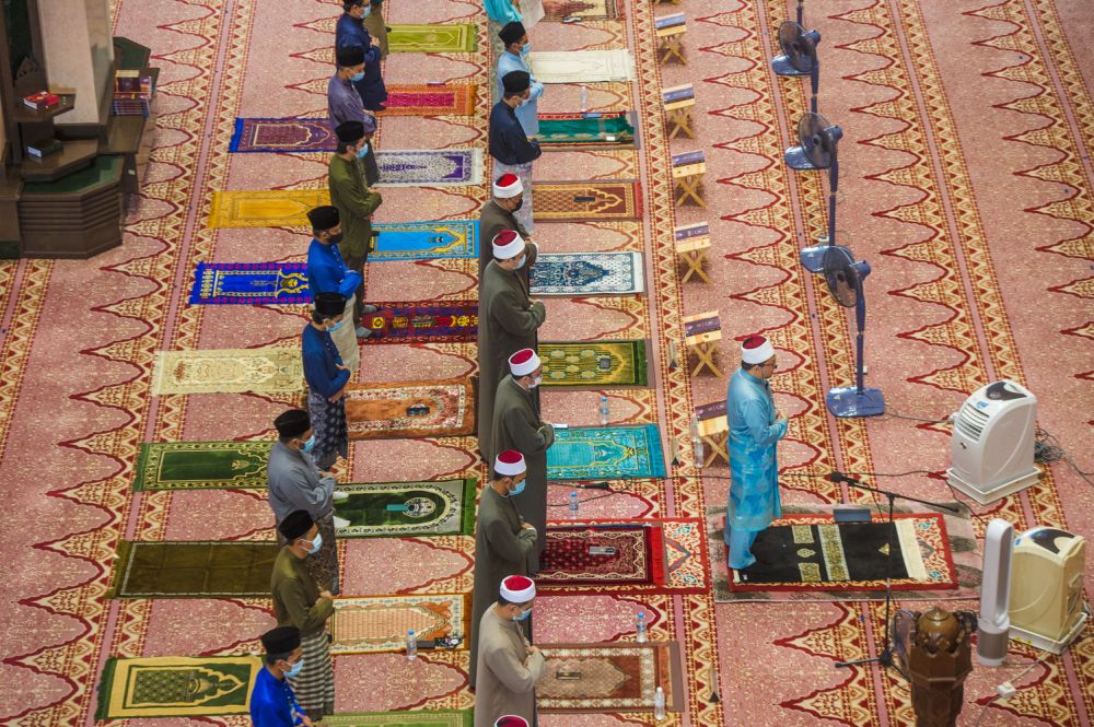 Muslims observe social distancing while performing Aidilfitri prayers at Masjid Putra, in Putrajaya, on the first day of Raya May 13, 2021. u00e2u20acu201d Picture by Shafwan Zaidon