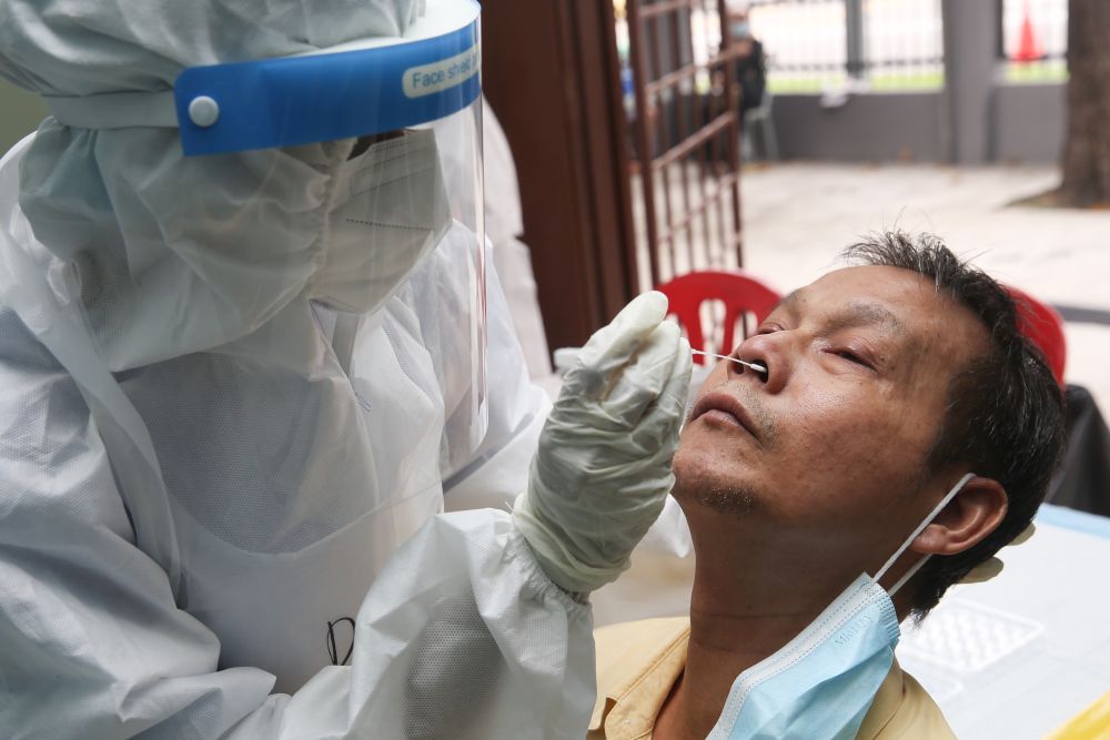 A health worker collects swab samples to test for Covid-19 at the MBPJ community hall in Taman Medan, Petaling Jaya May 24, 2021. u00e2u20acu201d Picture by Choo Choy May