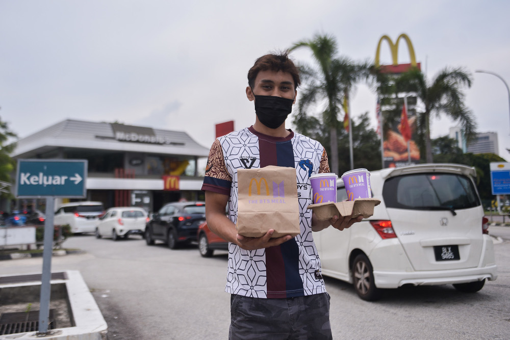 A customer poses with his BTS Meal at the McDonaldu00e2u20acu2122s outlet in Seksyen 3, Shah Alam May 26, 2021. u00e2u20acu201d Picture by Miera Zulyanan