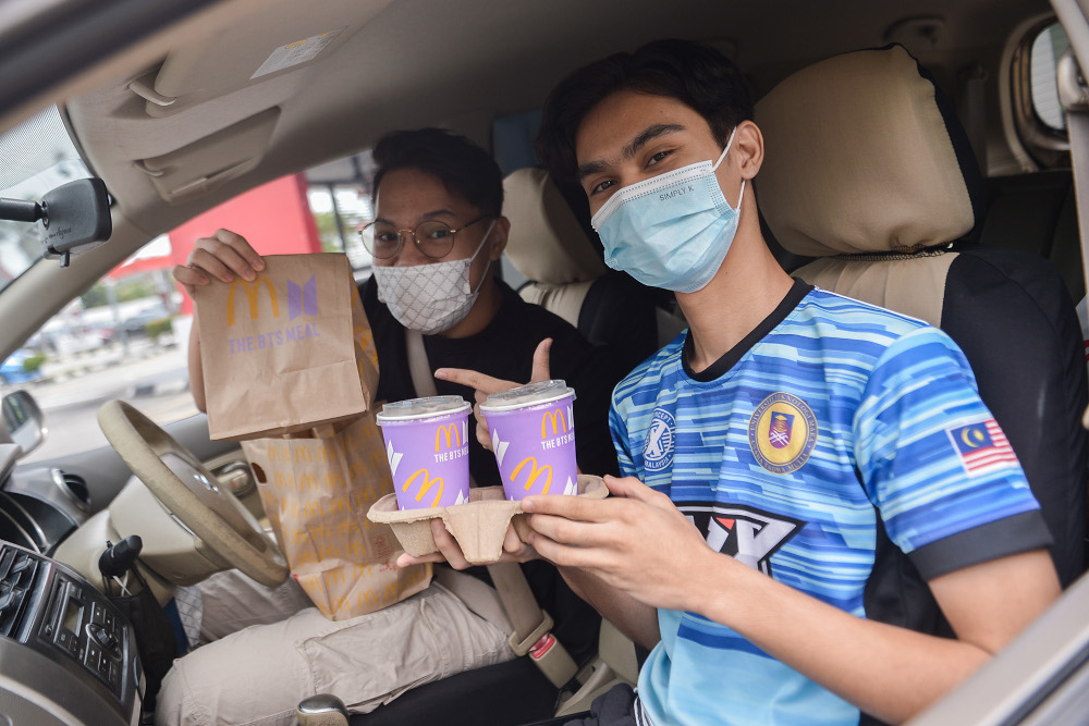 Customers pose with their BTS Meal at a McDonaldu00e2u20acu2122s outlet in Seksyen 3, Shah Alam May 26, 2021. u00e2u20acu201d Picture by Miera Zulyanan