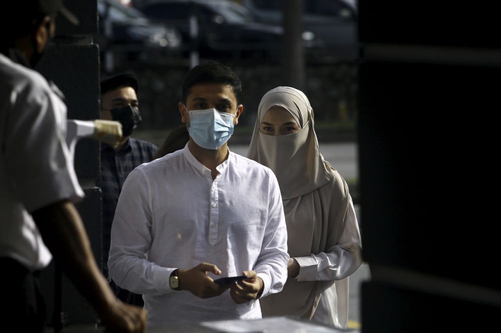 Noor Neelofa Mohd Noor and her husband Muhammad Haris Mohd Ismail arrive at the Seremban Magistrateu00e2u20acu2122s Court May 20, 2021. u00e2u20acu201d Bernama pic