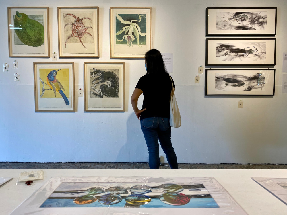 A visitor admiring the artwork during the exhibition at Hin Bus Depot. u00e2u20acu201d Picture by Steven Ooi KE